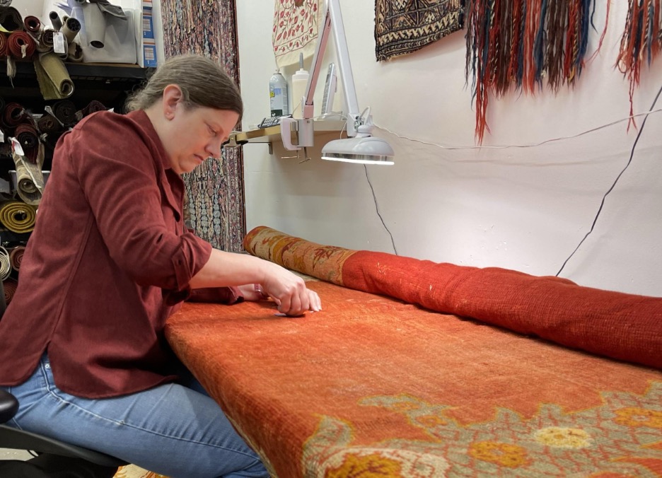 Technician applying rug protection treatment in a Chicago home