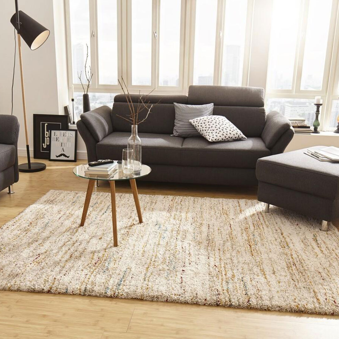 beige rug with dark gray sofa