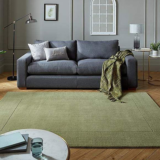 Sage green rug + dark gray couch